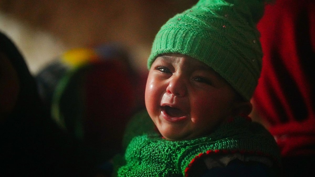 <div class="paragraphs"><p>Slain Policeman Mohammad Sultan's three month old baby at the funeral home in Sopore.</p></div>