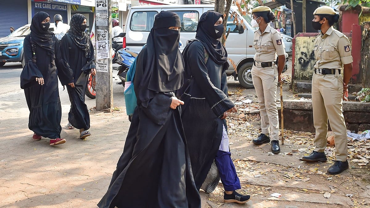 <div class="paragraphs"><p>Students arrive to attend a school that reopened after Karnataka High Court's interim order restraining students from wearing religious symbols inside the classroom, in Udupi.<br></p></div>