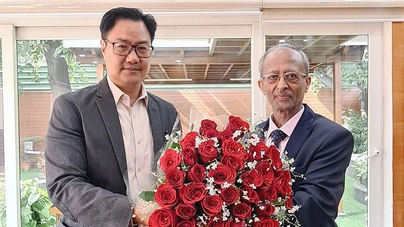 <div class="paragraphs"><p>Anoop Kumar Mendiratta with Law Minister Kiren Rijiju.</p></div>