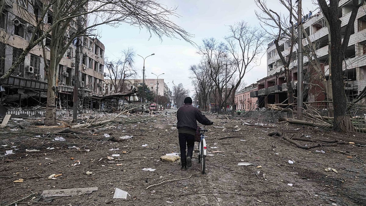 <div class="paragraphs"><p>A man walks with a bicycle in a street damaged by shelling in Mariupol, Ukraine.</p></div>