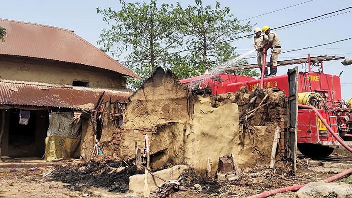 <div class="paragraphs"><p>Firefighters dousing the fire in one of the burnt houses in Rampurhat, Birbhum on Tuesday, 22 March.</p></div>