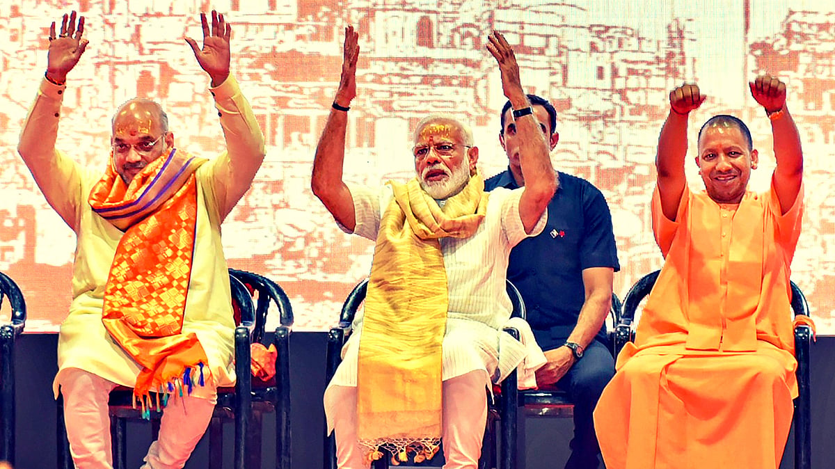 <div class="paragraphs"><p>File photo of PM Narendra Modi (centre), Uttar Pradesh CM Yogi Adityanath (right) and Home Minister Amit Shah (left) greeting BJP workers in Varanasi.</p></div>