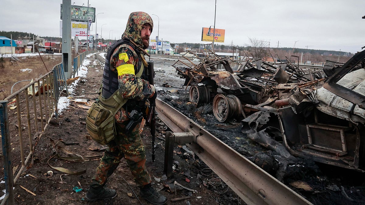 <div class="paragraphs"><p>Catch all the live updates on the Russia-Ukraine war here. An armed man stands by the remains of a Russian military vehicle in Bucha, close to the capital Kyiv, Ukraine.</p></div>