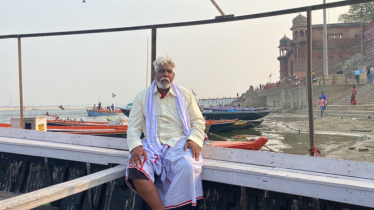 <div class="paragraphs"><p>Pramod Manjhi on his boat at the Shivala Ghat</p></div>
