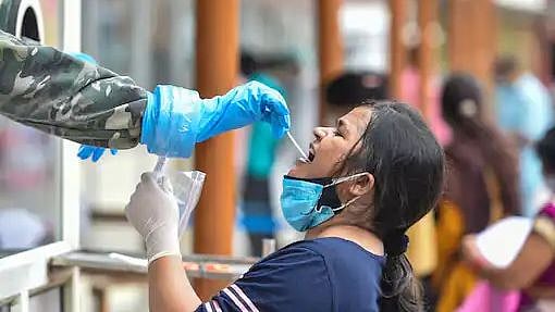 <div class="paragraphs"><p>A woman gets tested for COVID in Uttar Pradesh.</p></div>