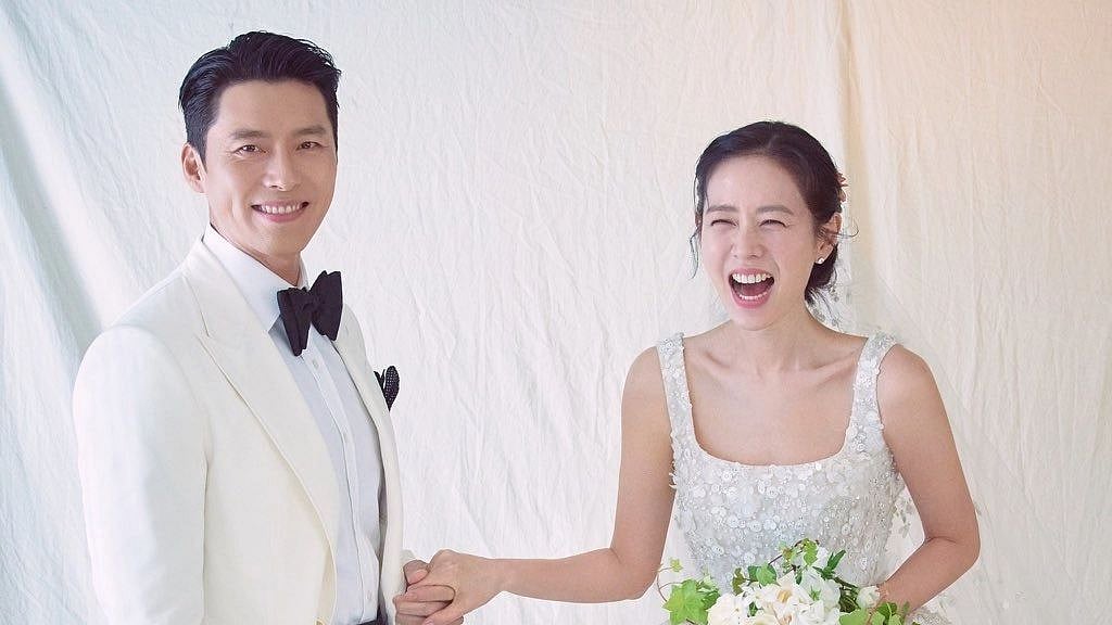 <div class="paragraphs"><p>Hyun Bin and Son Ye-jin in their wedding outfits.</p></div>