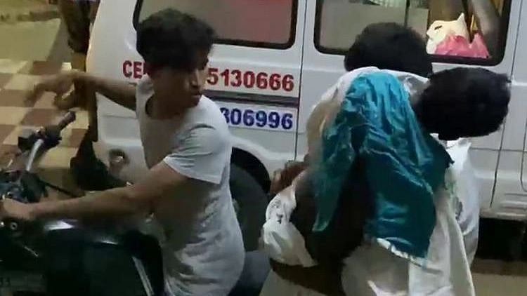 <div class="paragraphs"><p>Ten-year-old boy’s body being carried on a bike outside Tirupati Ruia GGH.</p></div>