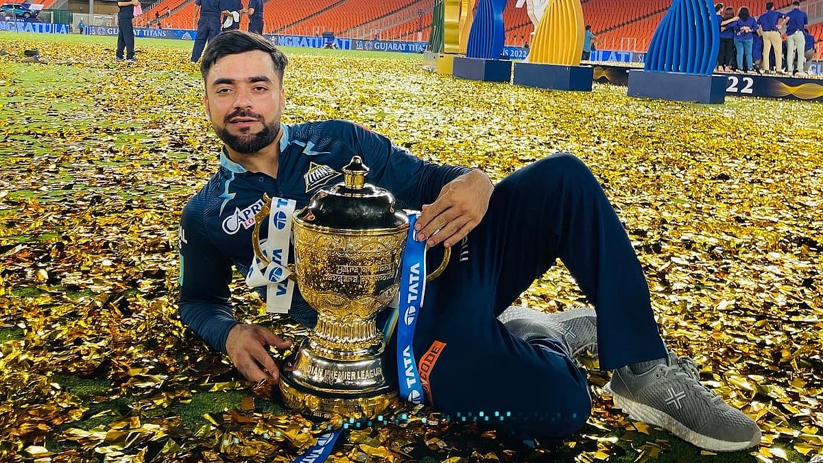 <div class="paragraphs"><p>Gujarat Titans bowler Rashid Khan posing with the IPL 2022 trophy after the final.</p></div>