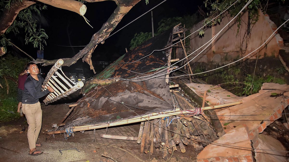 <div class="paragraphs"><p>People try to clear debris after a boundary wall of Assam Engineering Institute (AEI) collapsed due to heavy rainfall, in Guwahati, Saturday night,</p></div>