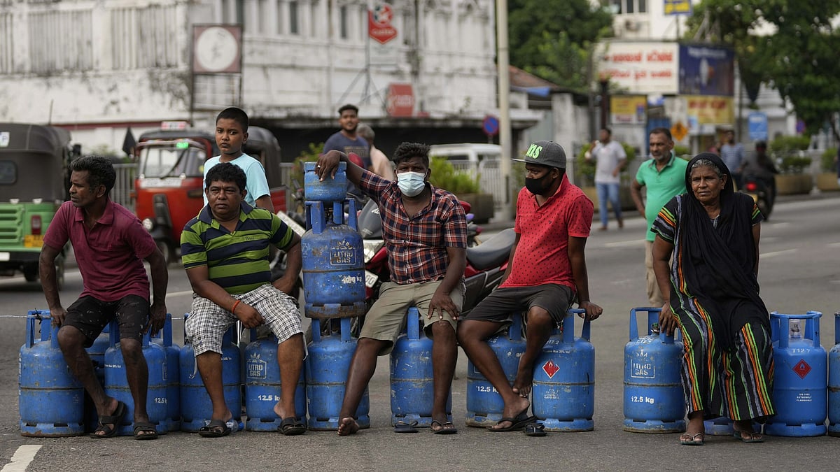 <div class="paragraphs"><p>Sri Lankans block an intersection demanding cooking gas cylinders in Colombo on 7 May. </p></div>