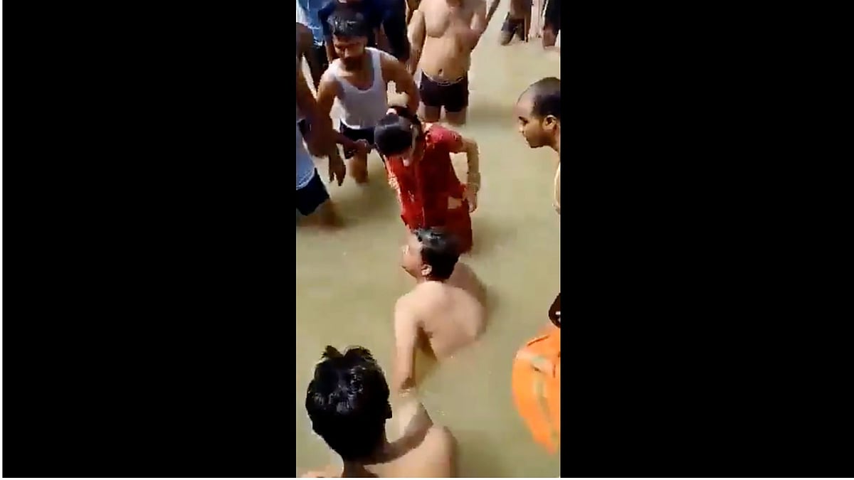 <div class="paragraphs"><p>The video shows him being surrounded, dragged out of the river and being beaten by the men.</p></div>