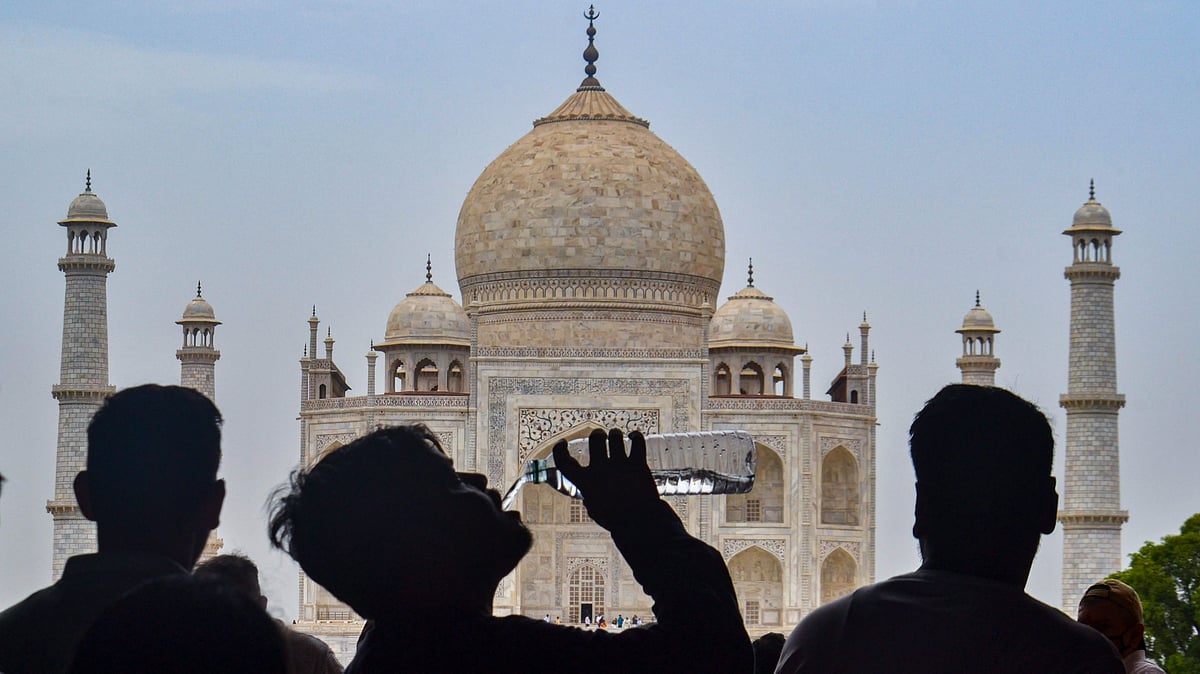 <div class="paragraphs"><p>A tourist drinks water to stay hydrated on a hot summer day, at the Taj Mahal, in Agra, Tuesday, 14 June 2022.</p></div>