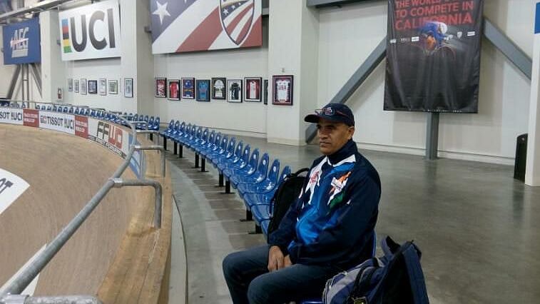 <div class="paragraphs"><p>Rajender Kumar Sharma sitting in the stands during training.</p></div>