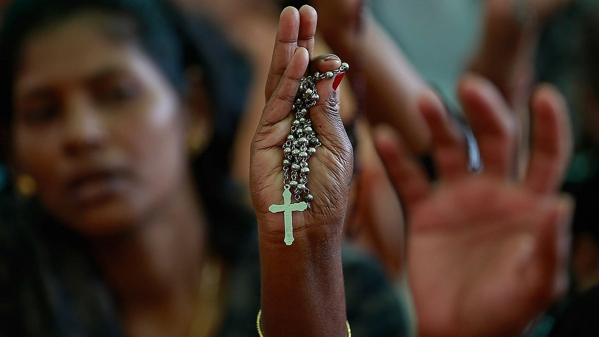 <div class="paragraphs"><p> A protester holds a cross during a protest rally. Image for representational purposes.</p></div>