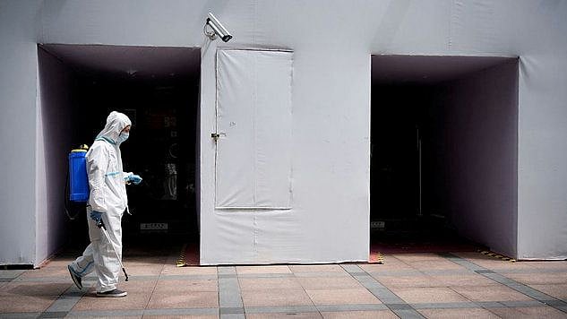 <div class="paragraphs"><p>A worker in a protective suit disinfecting the area. Image used for representation.</p></div>