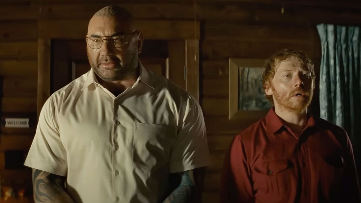 <div class="paragraphs"><p>sta and Rupert Grint in a still from<em> Knock at the Cabin.</em></p></div>