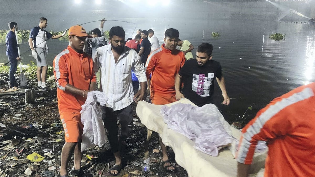 <div class="paragraphs"><p>NDRF personnel assist a victim during a rescue operation after an old suspension bridge over the Machchhu river collapsed, in Morbi district, early Monday, Oct. 31, 2022. </p></div>