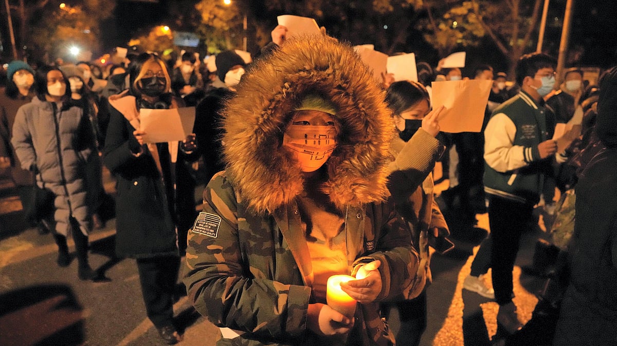 <div class="paragraphs"><p>Protesters hold up blank papers and chant slogans in Beijing as they march to protest against COVID-19 measures on Sunday, 27 November.&nbsp; </p></div>