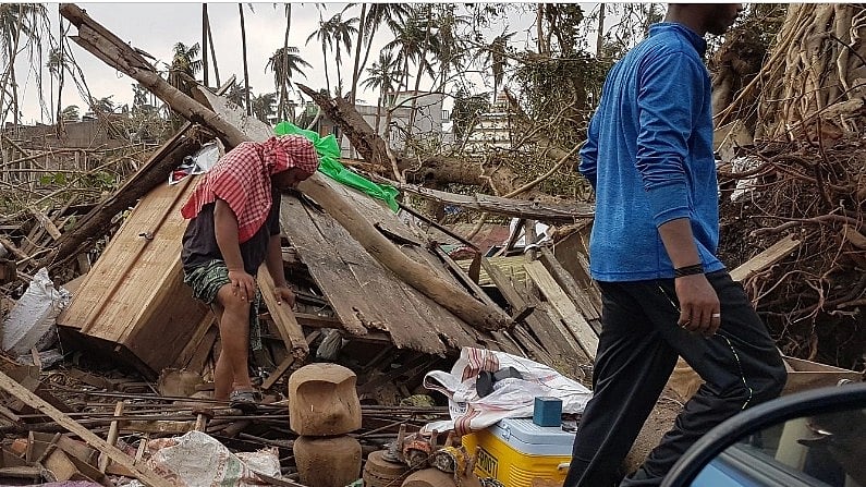 <div class="paragraphs"><p>A man looking at his damaged house on the outskirts of Puri a day after cyclone Fani hit Odisha in 2019. </p></div>