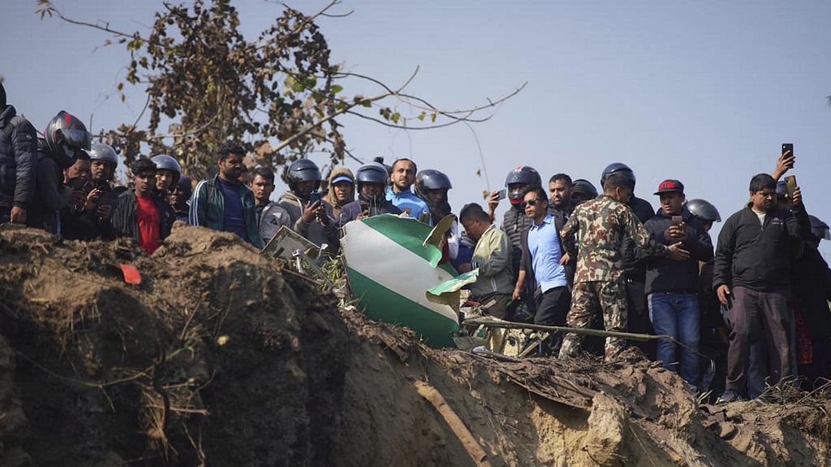 <div class="paragraphs"><p>Locals watch the wreckage of a passenger plane in Pokhara, Nepal, Sunday, 15 January.</p></div>