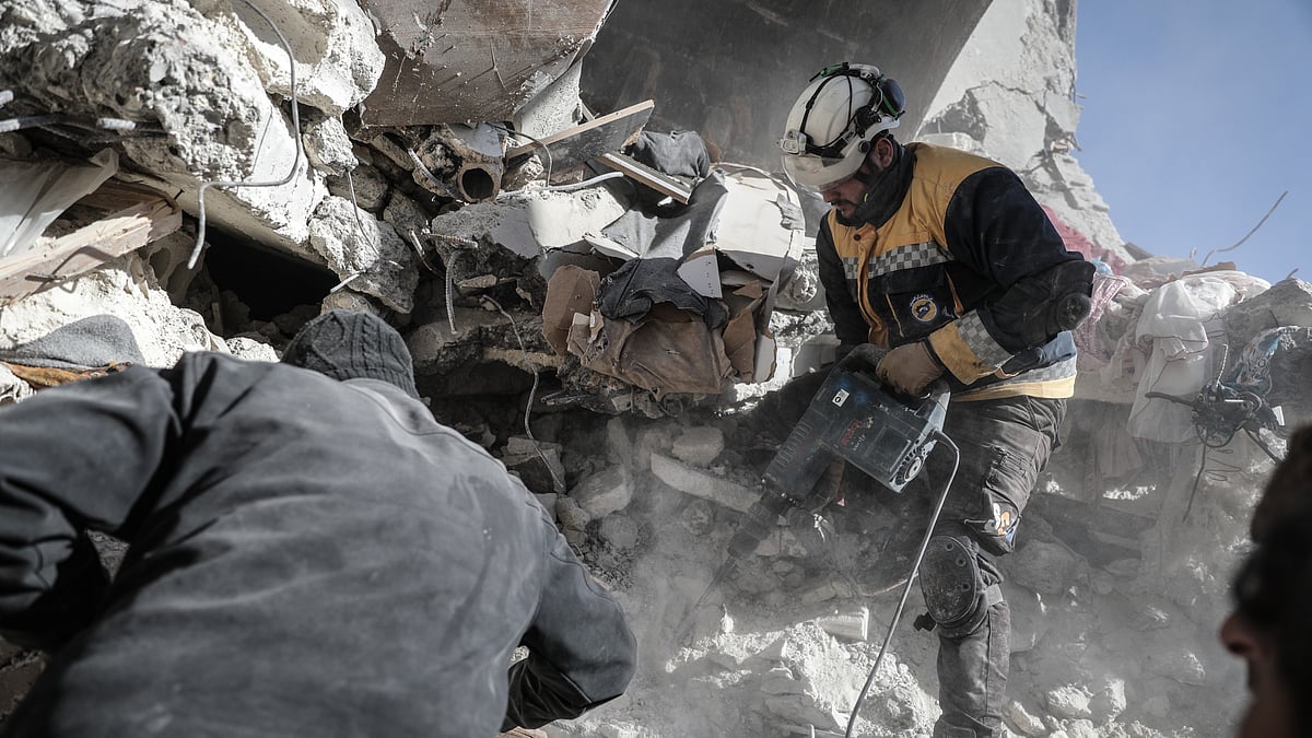 <div class="paragraphs"><p>A volunteer hard at work to find survivors in a village in northwestern Syria. </p></div>
