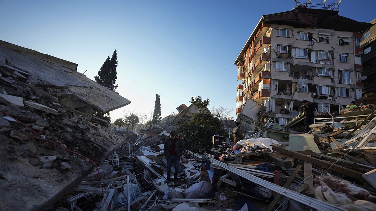 <div class="paragraphs"><p>A man walks through the rubble of destroyed buildings in Antakya, southern Turkey. </p></div>