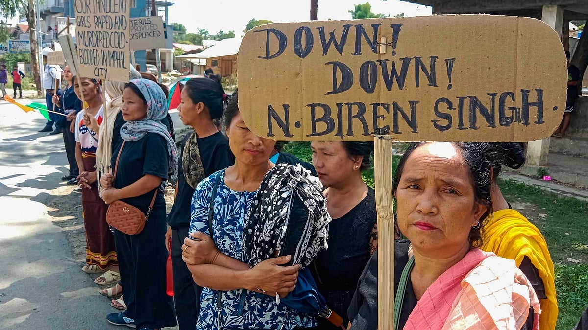 <div class="paragraphs"><p>Kuki tribals holding a placard take part in a rally at Churachandpur in Manipur. </p></div>