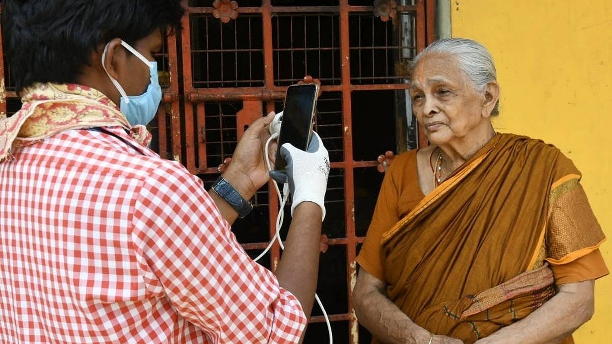 <div class="paragraphs"><p>A village volunteer collecting the photo of a welfare beneficiary.</p></div>