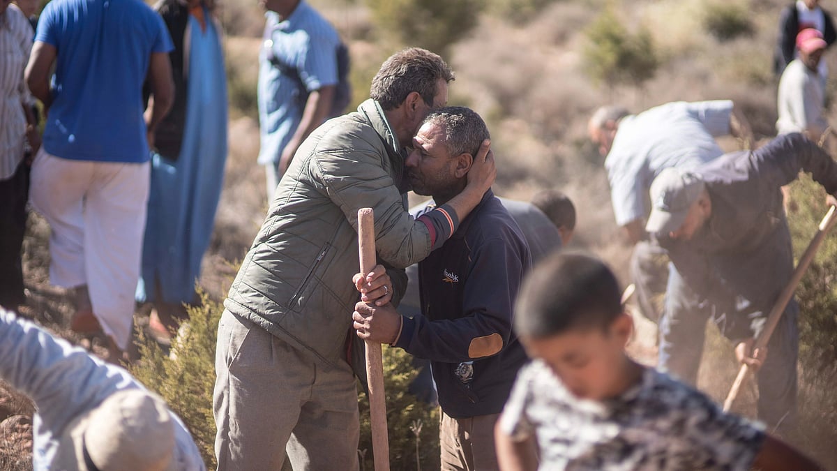 <div class="paragraphs"><p>People comfort each other while digging graves for victims of the earthquake, in Ouargane village, near Marrakech, Morocco, on Saturday, 9 September. </p></div>