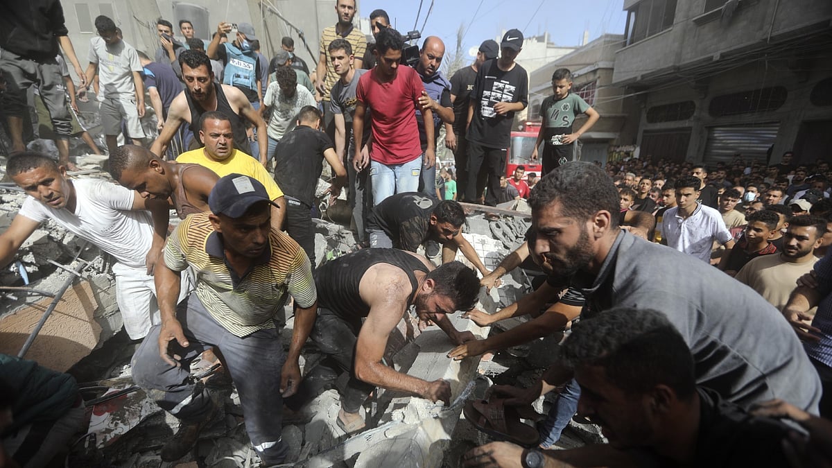 <div class="paragraphs"><p>Palestinians look for survivors under the rubble of a destroyed building following an Israeli airstrike in Khan Younis refugee camp, southern Gaza Strip.</p></div>