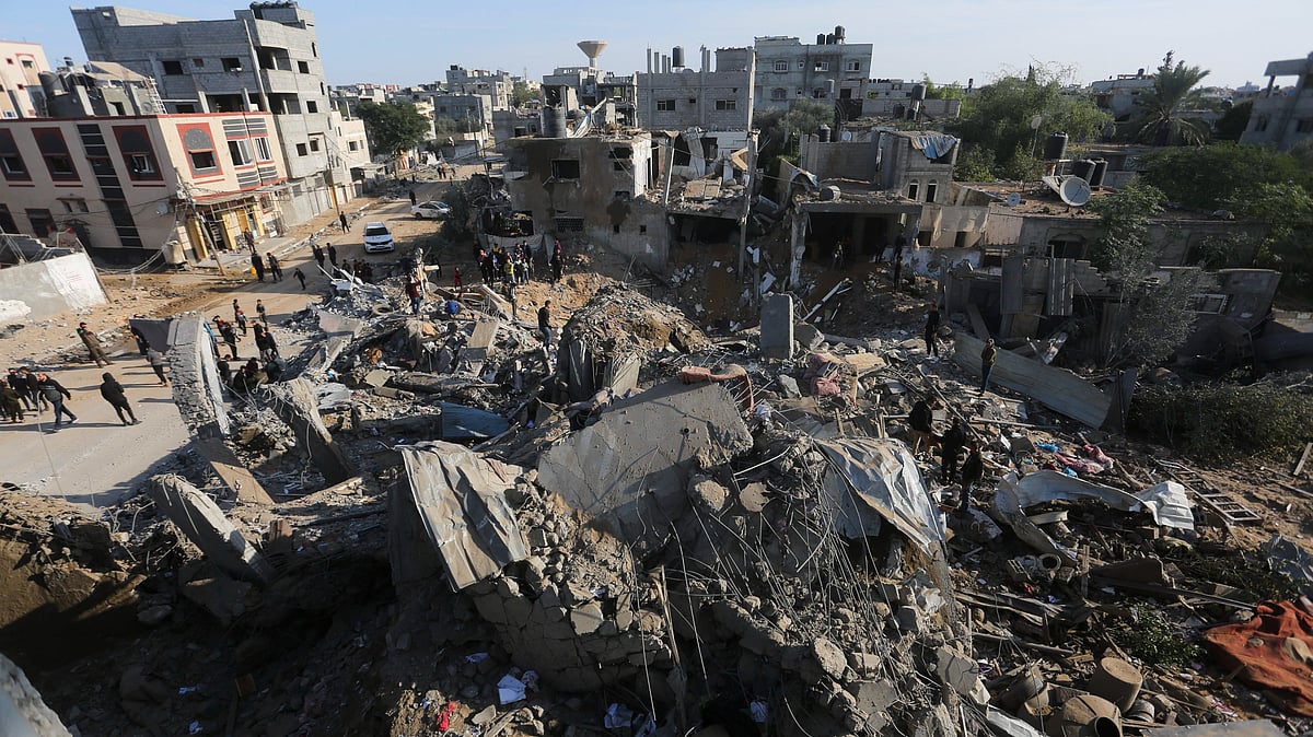 <div class="paragraphs"><p>Palestinians look upon the destruction caused by Israeli bombardment of the Gaza Strip in Rafah on Monday, 4 December.&nbsp;</p></div>