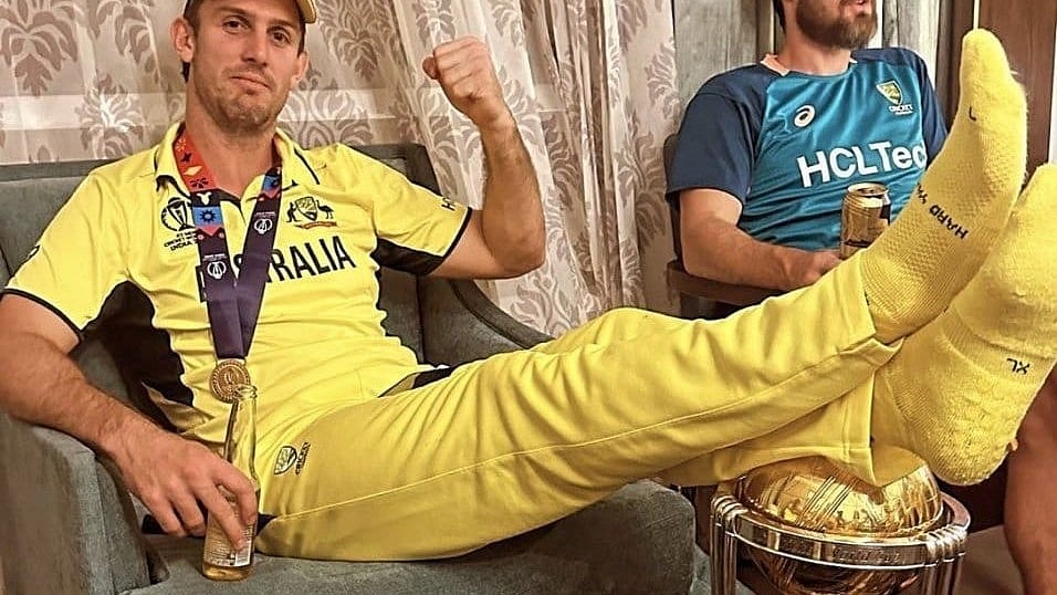 <div class="paragraphs"><p>Australia's Mitchell Marsh poses with the World Cup trophy after Aus defeated India.</p></div>