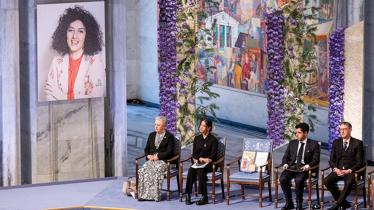 <div class="paragraphs"><p>A large portrait on display showed Narges Mohammadi in pastel colors and smiling. “She has asked us to use this particular photograph, which expresses how she wants to lead her life, looking happy in colourful garments, exposing her hair and with a steady gaze towards us,” said Berit Reiss-Andersen, chairwoman of the Norwegian Nobel Committee.</p></div>
