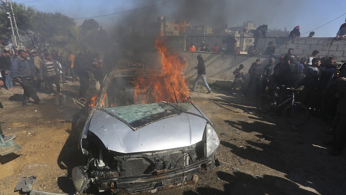 <div class="paragraphs"><p>Palestinians watch a car burn after it was hit by an Israeli in Rafah, Gaza Strip. </p></div>