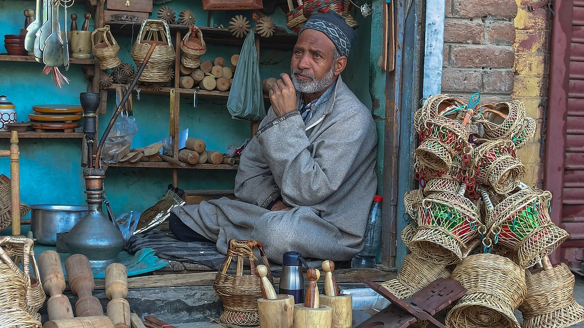 <div class="paragraphs"><p>An artisan in Charar-i-Sharief in Kashmir's Budgam district, displays his kangris.</p></div>