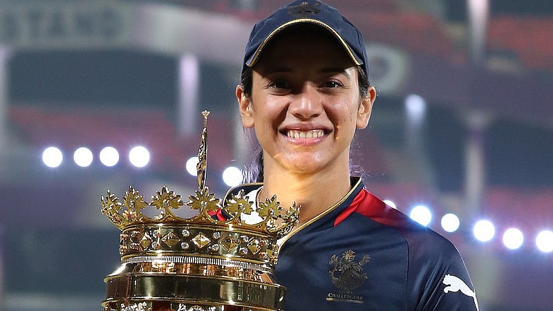 <div class="paragraphs"><p>Smriti Mandhana (c) of Royal Challengers Bangalore poses with the winners trophy during the final of the Women’s Premier League 2024 between Delhi Capitals and Royal Challengers Bangalore held at the Arun Jaitley Stadium, New Delhi</p></div>
