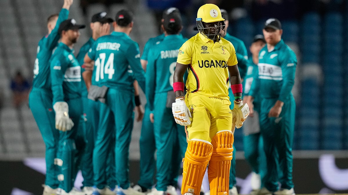 <div class="paragraphs"><p>Simon Ssesazi walks off the field after being trapped LBW for a duck by New Zealands Trent Boult during an ICC Men's T20 World Cup cricket match at the Brian Lara Cricket Academy in Tarouba, Trinidad and Tobago</p></div>