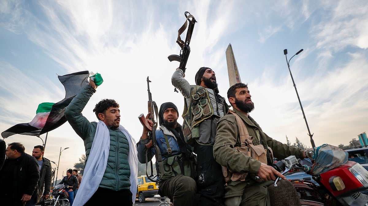<div class="paragraphs"><p>Syrian opposition fighters celebrate in Damascus on Sunday, 8 December, after the fall of the Bashar Assad-led government. </p></div>