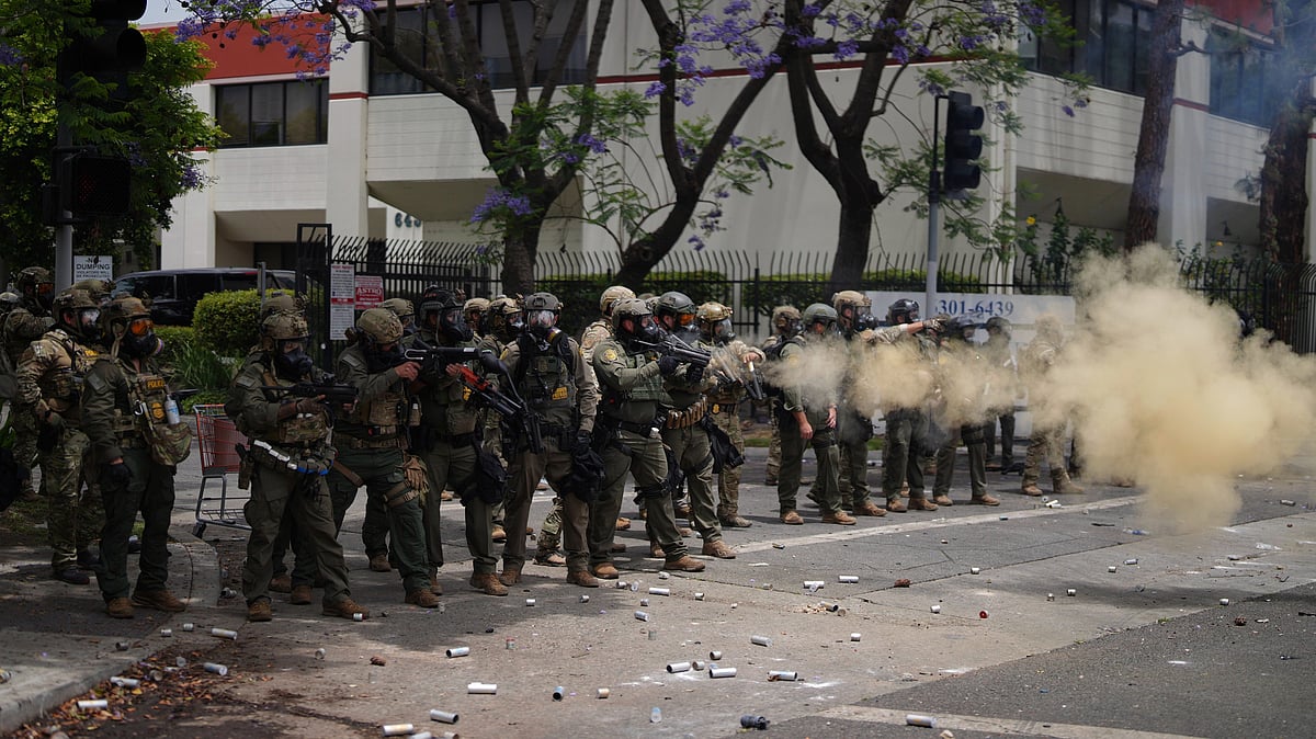 <div class="paragraphs"><p>Border Patrol personnel deploy tear gas during a demonstration over the dozens detained in an operation by federal immigration authorities a day earlier in the Paramount section of Los Angeles on Saturday, 7 June.</p></div>