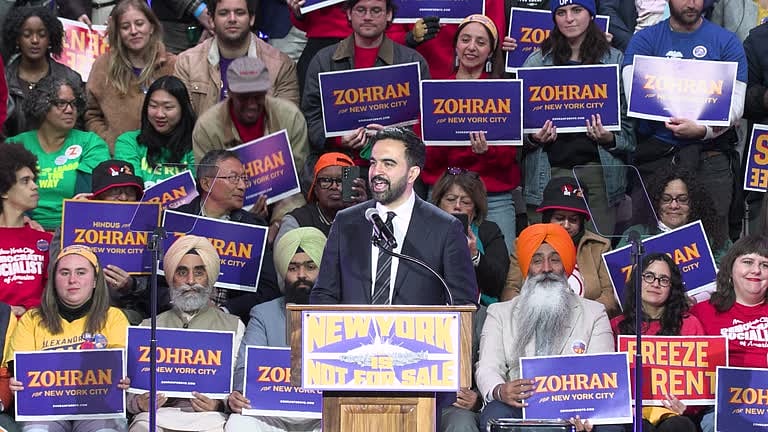 <div class="paragraphs"><p>Zohran Mamdani giving a speech at an event recently with members of the Indian American community in the background.&nbsp;</p></div>