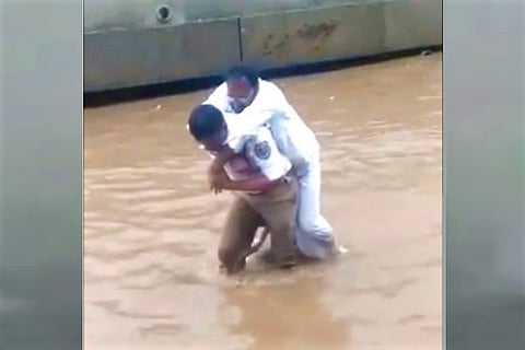 Watch: Traffic cop rescues man, carries him across waterlogged road in Hyderabad