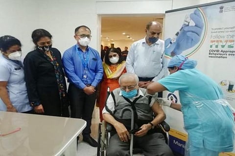A senior citizen being administered with the vaccine