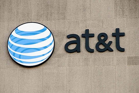 Board saying at&t with a blue and white sphere logo