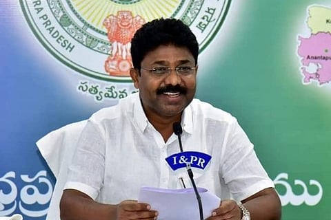 Education Minister Adimalupu Suresh in a white shirt addressing the media