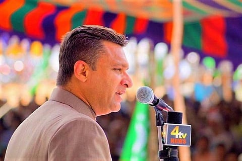 Akbaruddin Owaisi speaking into a mic and addressing a gathering