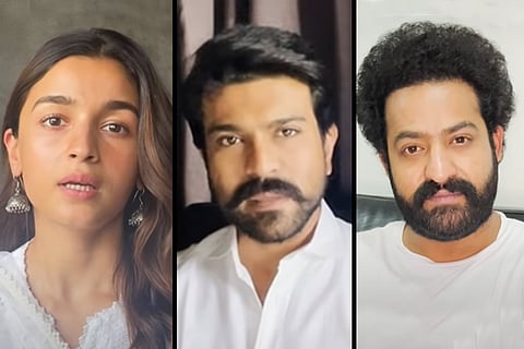 Actor Alia Bhatt is seen on the left, actor Jr NTR on the right and actor Ram Charan in the center.