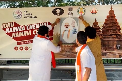 Amar Prasad Reddy pasting a picture of Prime Minister Narendra Modi 