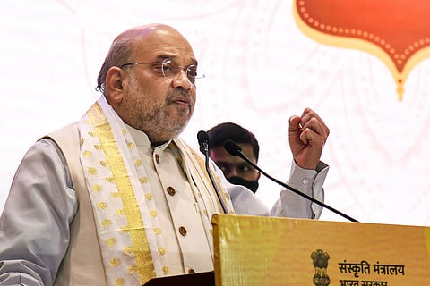 Union Home Minister Amit Shah speaking into a mic