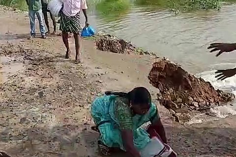 Screengrab of the woman crossing a road that is about to cave in 