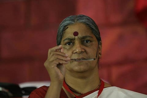 CPI leader Annie Raja wearing big bindi and holding her specs 